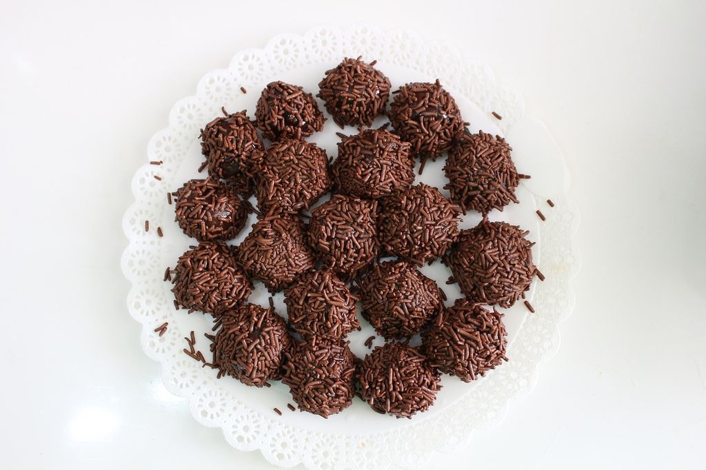 Brigadeiro chocolate snacks from Brazil on a white plate. 