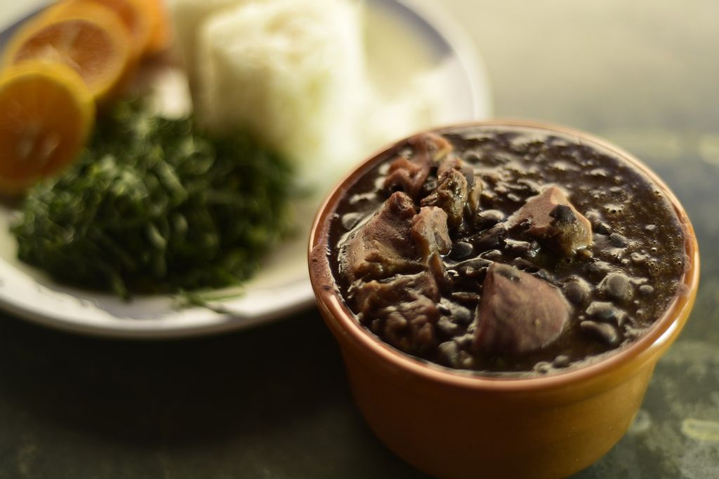 Feijoada bean stew in a brown bowl