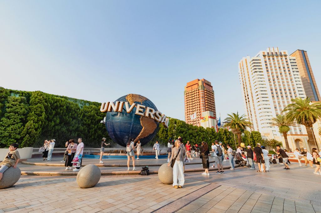 people standing in front of the Universal Studios Japan globe