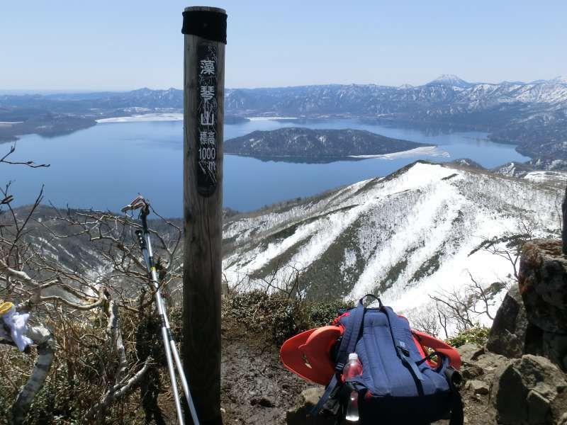 Shiretoko / Abashiri Private Tour - At the top of Mt.Mokoto (1,000m high) in spring. We can enjoy the view of Lake Kusharo, which is the largest crater lake in Japan. This area is designated as a part of Akan Mashu National Park. People enjoy snowshoeing in winter here.