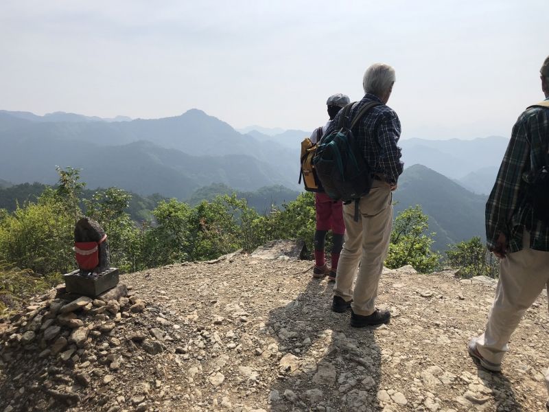 Wakayama Private Tour - A small "Jizo" statue at "Hyakken-Gura" on "Kogumotori-goe" route. We are looking at "Saiho-rakudo" the western paradise.