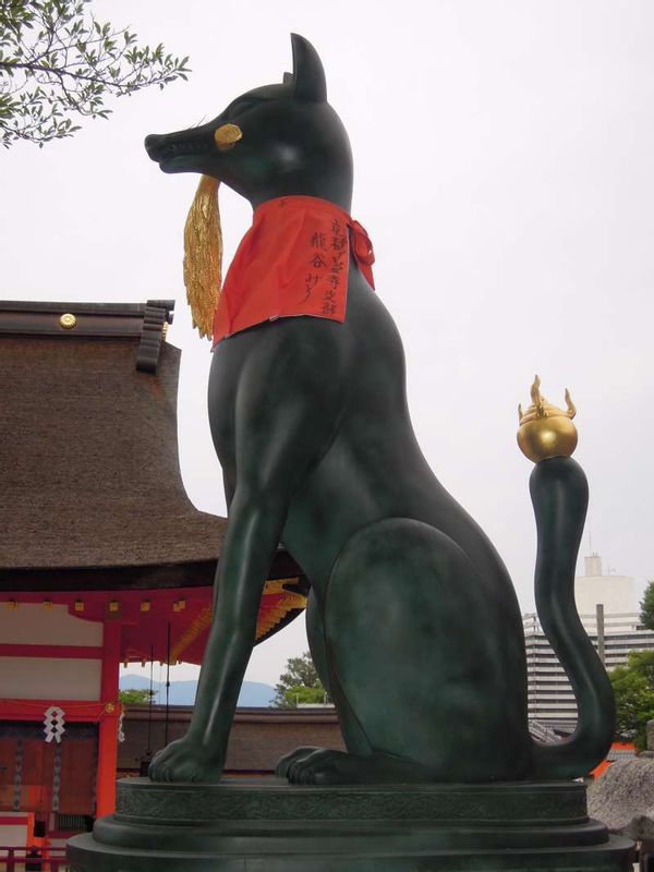 Kyoto Private Tour - One of the pair of bronze foxes placed in front of the oratory hall of Fushimi Inari Grand Shrine    Foxes are symbolic animals of Inari shrines which enshrine the kami or deity of harvest.  