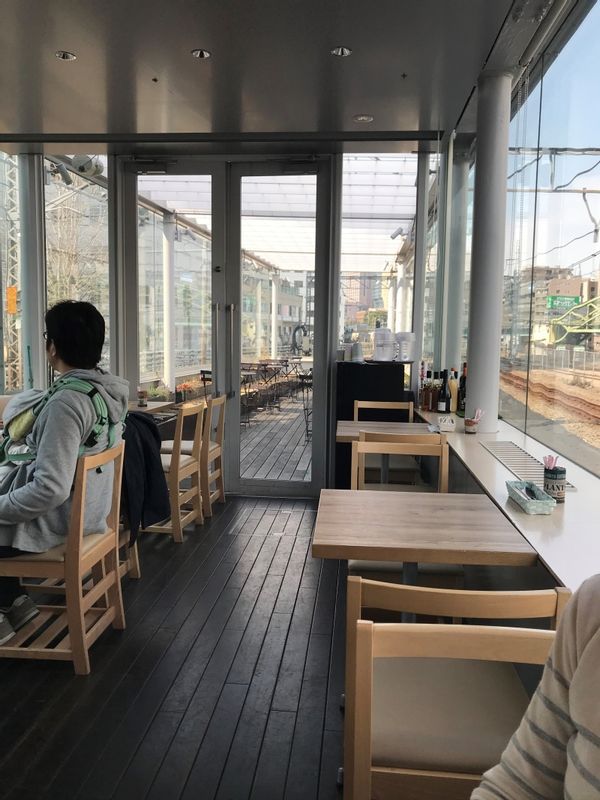 Tokyo Private Tour - A cafe in between two railway tracks.  It was renovated from an old railway station.  You can see trains going on both sides just across the window.