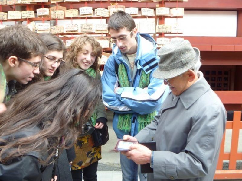 Tokyo Private Tour - Early Spring in Kamakura city, Kanagawa prefecture. 
A gentleman explained Japan's ritual to write one's petition on votive tablet in TSURUGAOKA Hachimangu, Shintoism's shrine.