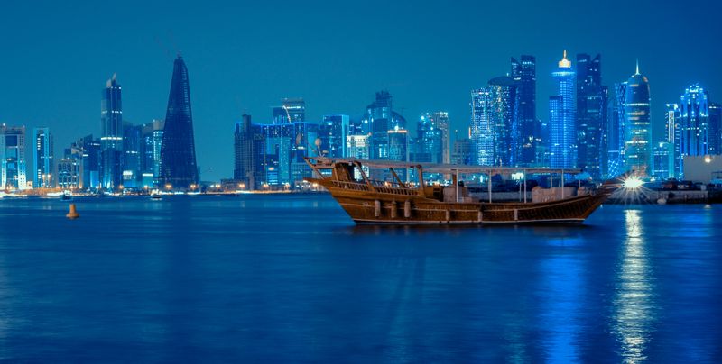 Doha Private Tour - Doha skyline at night with Dhow boat