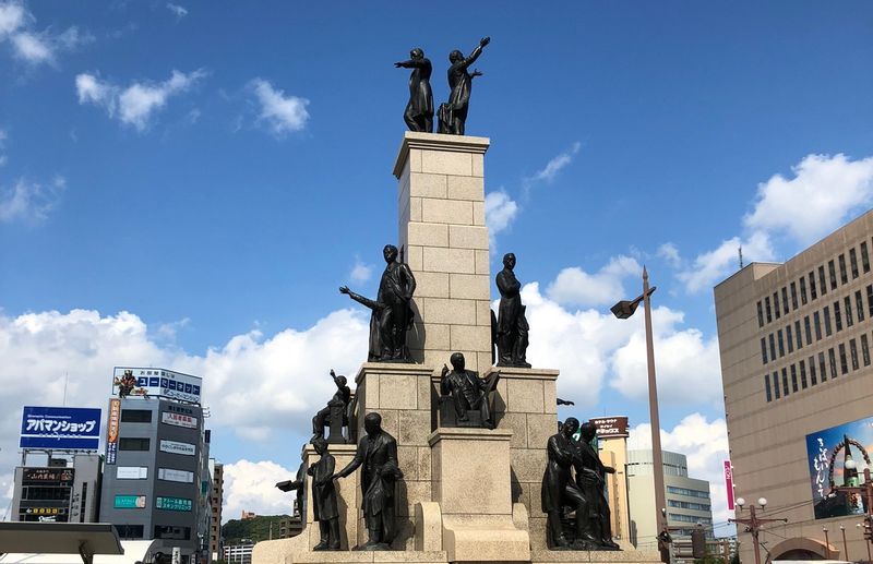 Kagoshima Private Tour - A group of young Satsuma statues in front of Kagoshima Chuo Station.