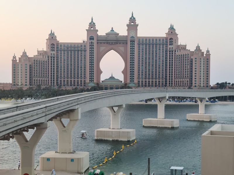 Dubai Private Tour - The tree-shaped Palm Jumeirah island is known for glitzy hotels, posh apartment towers and upmarket global restaurants. Food trucks offering snacks like shawarma dot the Palm Jumeirah Boardwalk, popular for its views of the Dubai coastline and the sail-shaped Burj Al Arab hotel.