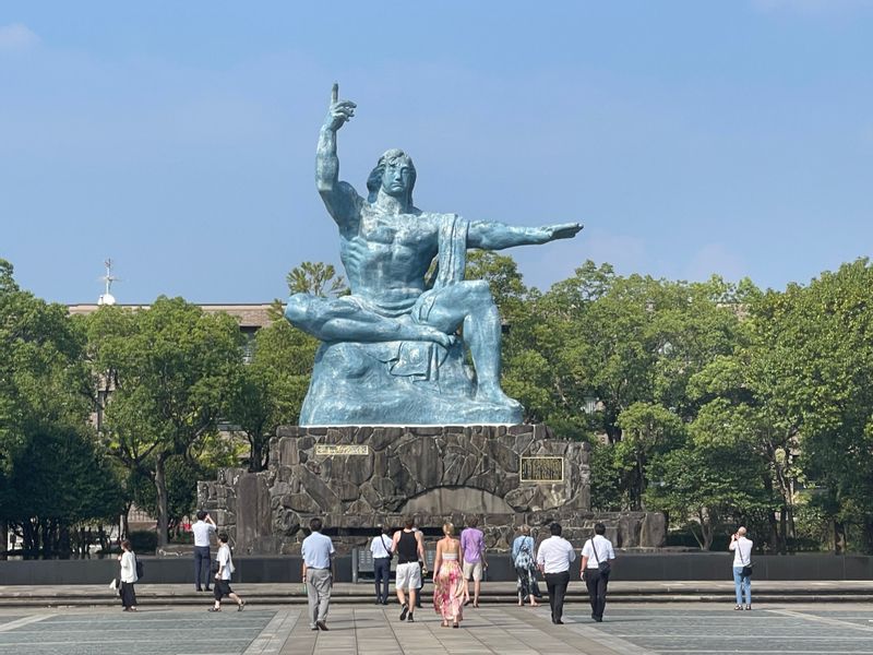 Nagasaki Private Tour - The Nagasaki Peace Statue--left hand, "see what prosperity peace brings;" right hand, "Warning of the use of nuclear weapons."