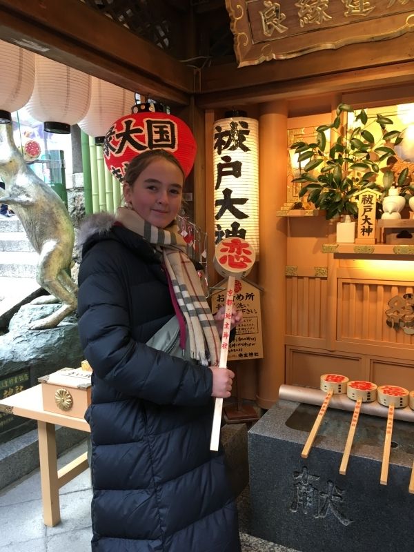 Osaka Private Tour - She is holding   “My sweat first love”ladle at couple shrine in Kiyomizu temple.