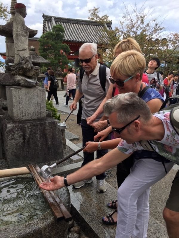 Kobe Private Tour - Experience of purifying oneself at Fushimi Inari Shrine in Kyoto. Firstly, scoop some water with a ladle by your right hand and then pour some water over your left hand. Next purify your right hand. Secondly, rinse your lips slightly with water by your left hand. Finally, put the ladle where it was.