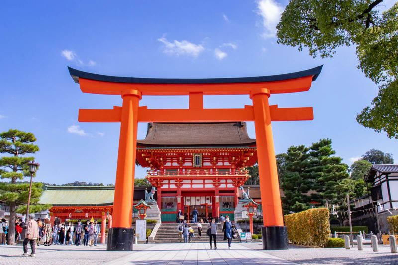 Osaka Private Tour - The front torii gate and the main gate of Fushimi-nari Shine on the background 