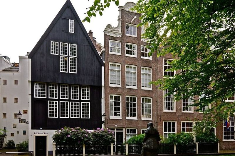 Amsterdam Private Tour - The oldest city's wooden house ( on left) situated in Begijnhof yard