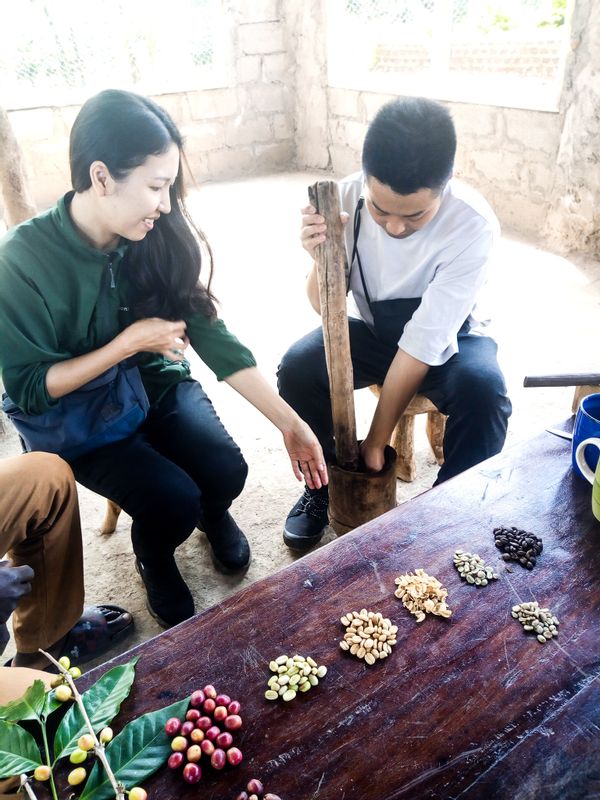 Mbale Private Tour - Tourists pounding coffee beans