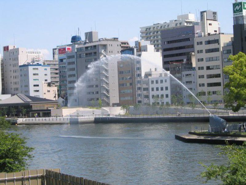 Osaka Private Tour - The fountain is squirting  in the daytime.