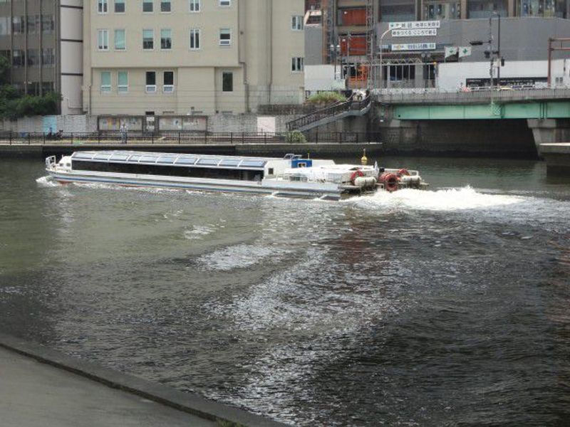 Osaka Private Tour - A aqua liner boat is cruising on Okawa river.