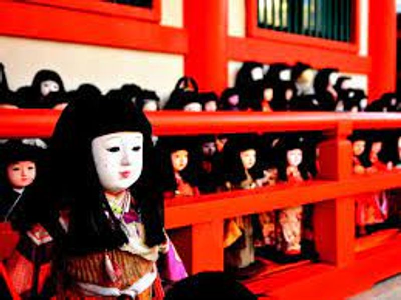 Osaka Private Tour - Many Japanese dolls are dedicated in front of the entrance of Awashima Shrine.