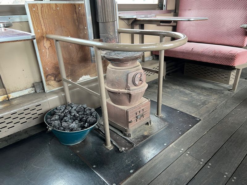 Aomori Private Tour - Coal stove in a train car