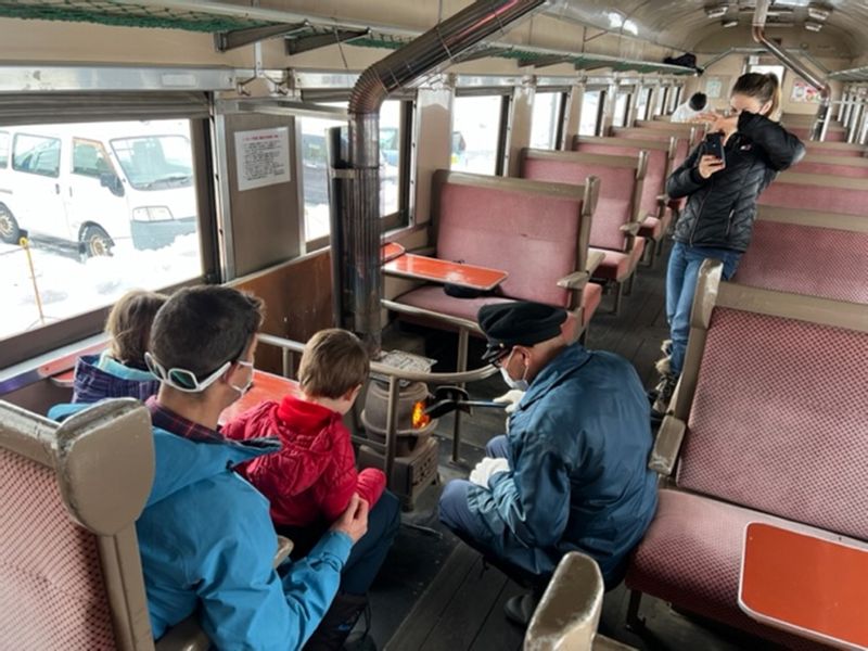 Aomori Private Tour - A conductor takes care of the coal stove