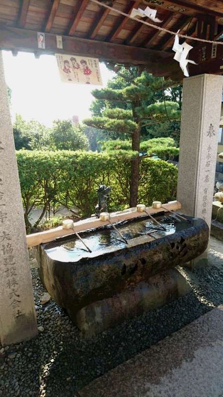 Ehime Private Tour - This is a washbasin. The water is used for purification of your body before standing in fron of the deity. Rinse your mouth and wash your hands. 
