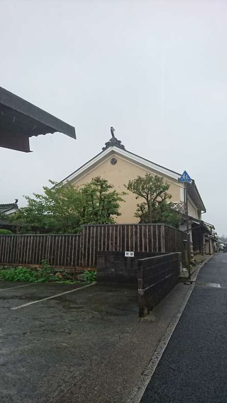 Ehime Private Tour - Pay attention to the decorative tile on the top of the roof. It serves a decoration as well as showing the owner's belief that it would protect the house from the fire disaster. A round shape thing below the tile is called Kegyo, which makes the end of the horizontal beam not seen from the outside. It is also a kind of decoration.