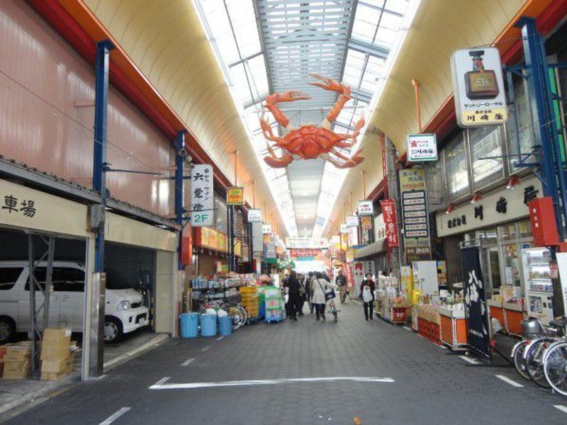 Osaka Private Tour - The signboard of  crab is hanging on the roof at Kuromon market.