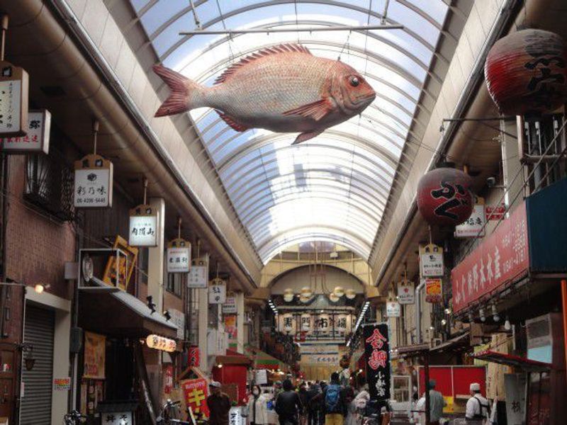 Osaka Private Tour - The signboard of seabream is hanging on the roof at Kuromon market.