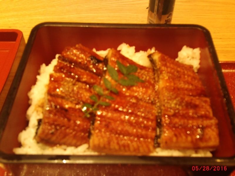 Osaka Private Tour - meal served in a wooden box, in which nicely cooked and flavored eel is placed on rice
