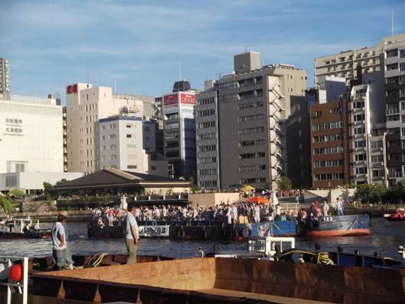 Osaka Private Tour - Raft with buildings in the background.