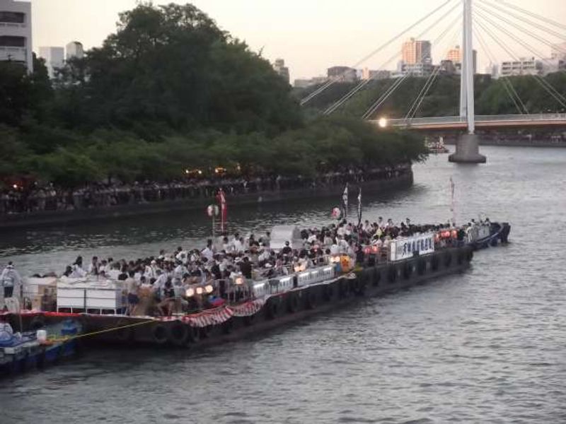 Osaka Private Tour - Rafts being towed upstream in the evening.