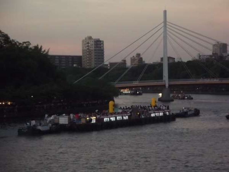 Osaka Private Tour - Rafts being towed upstream in the evening.