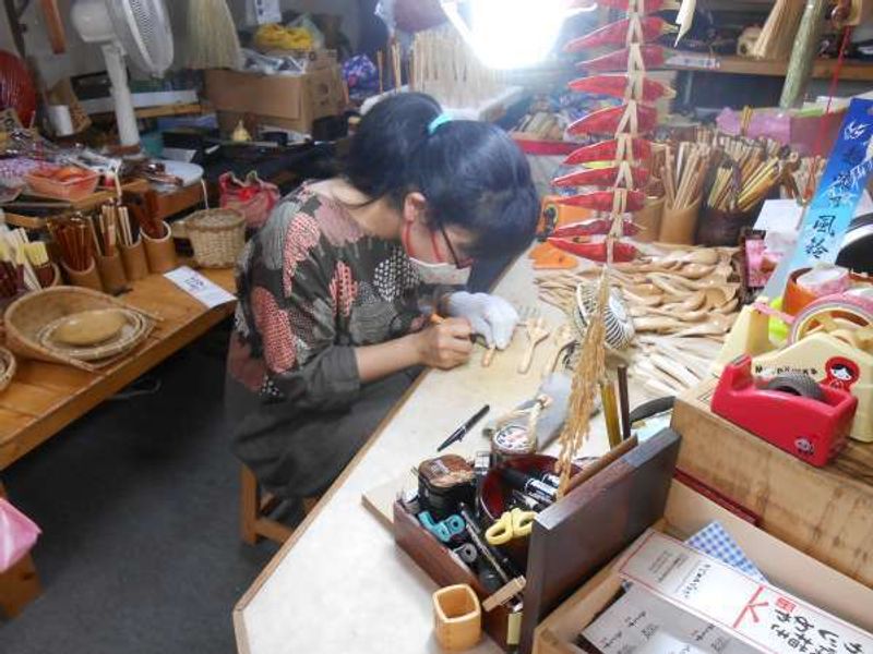 Ishikawa Private Tour - Writing your name service for customers at a Wajima lacquerware shop.