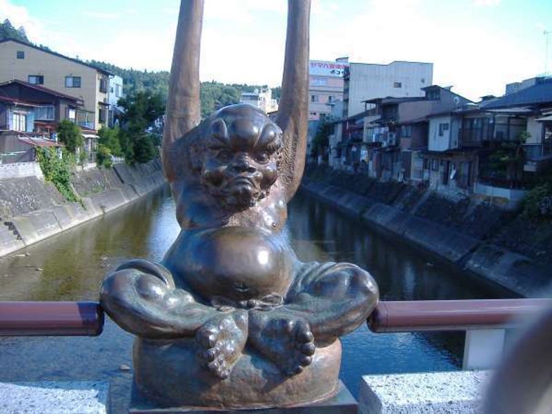 Gifu Private Tour - Tenaga creature sculpture sits on the Kajibashi bridge railing.