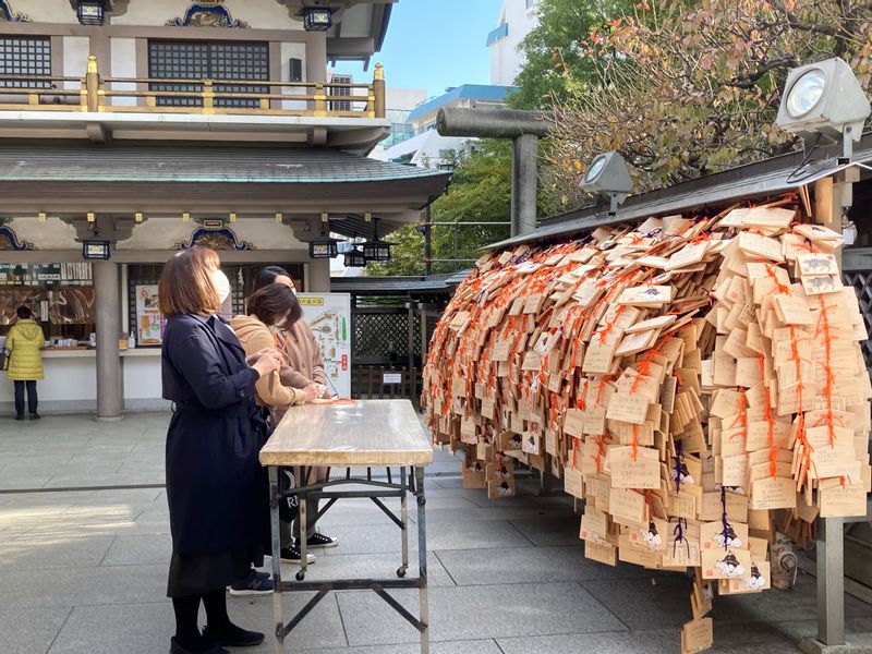 Tokyo Private Tour - A big bunch of Ema prayer plates in Yushima Tenjin Shrine