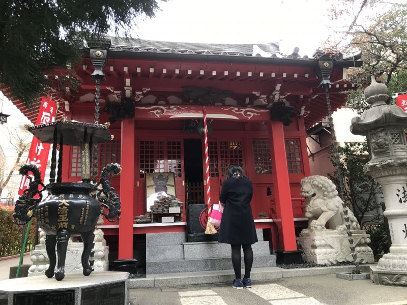 Tokyo Private Tour - A young lady was praying at a local temple of Kon'nyaku-Ema, Genkakuji.