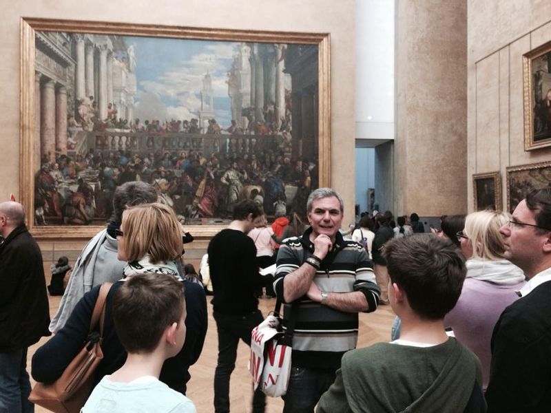 Paris Private Tour - Looking at Paolo Veronese's Wedding of Wedding Feast at Cana just in front of Leonardo da Vinci's Mona Lisa.