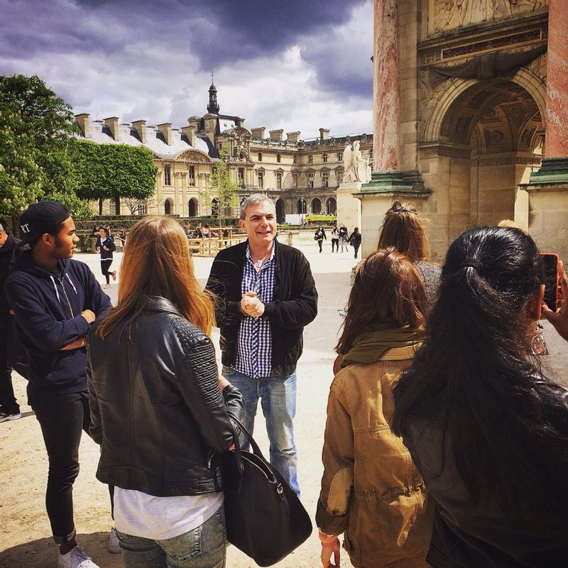 Paris Private Tour - The guide with the group at the Tuileries garden near Louvre.