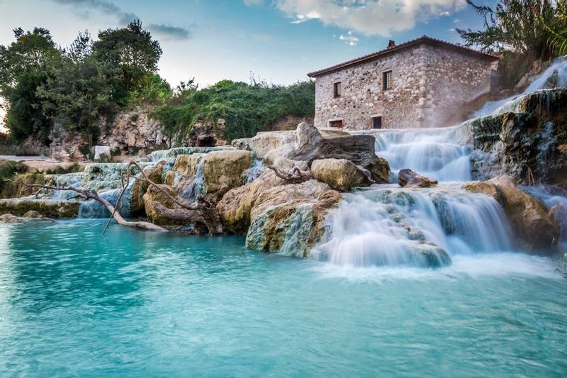 Rome Private Tour - Saturnia, from a plateau in the Albenya Valley, rises above the magical landscape of the Grossette hinterland among tuff boulders and green plains. To reach these beautiful places, you have to drive along the characteristic Tuscan village roads, which offer unforgettable views. 