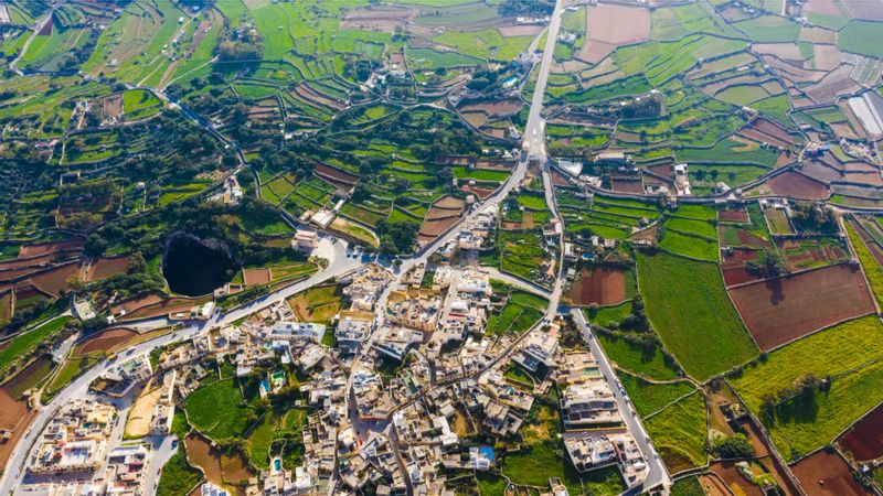 Malta Private Tour - Qrendi village from above, it is situated at the south west and is one of the oldest villages on our island. It goes back to Neolithic era. It became a parish in 1618 with population of 1024 where today we count up of 2800 residence only. The motto of the village is 'Tyrium Dirutas Servo Moles' means 'I conserve the buildings of the Phoenicians'. 