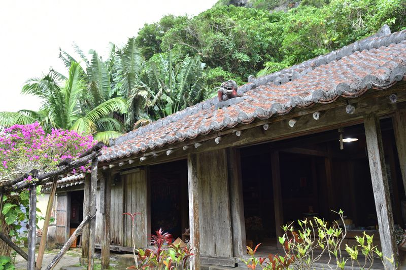 Okinawa Main Island Private Tour - A traditional Ryukyu-style house with a Shisa (guardian lion)