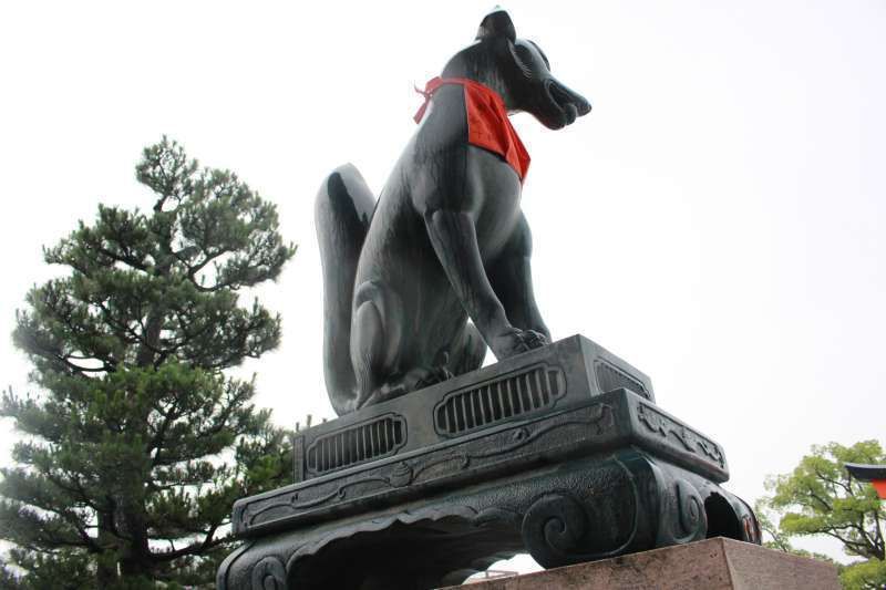 Kyoto Private Tour - Fushimi Inari Shrine. Byakko. Gods' messenger fox holding a stroll in its mouth.