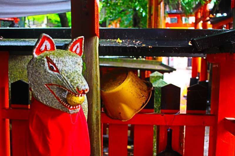 Kyoto Private Tour - Fushimi Inari Shrine. Byakko. Gods' messenger fox holding a stroll in its mouth.