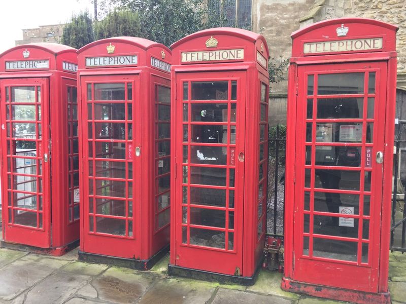 Cambridge Private Tour - A number of British telephone boxes in an orderly queue