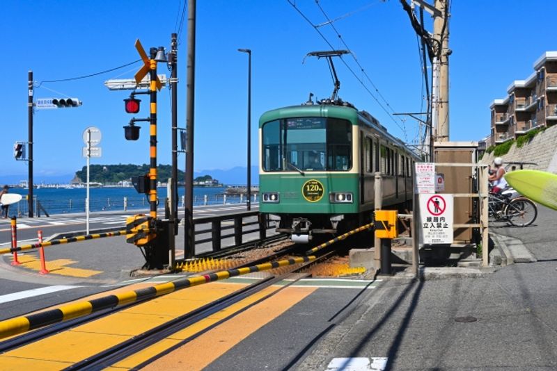 Tokyo Private Tour - A small train called Enoden runs by the ocean.