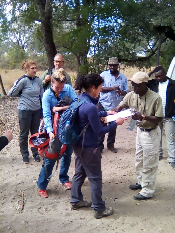 Livingstone Private Tour - Travelers signing in a travel manifest before boarding the vehicle