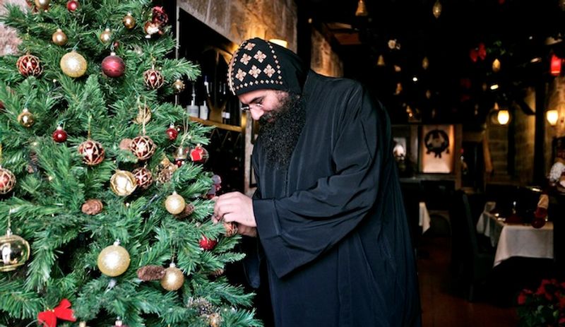 Jerusalem Private Tour - Armenian monk decorating a Christmas tree.