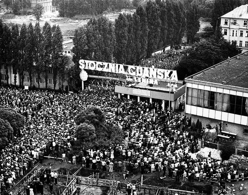 Gdansk Private Tour - Gate of Gdansk shipyard August 1980. 
Thousands of people are waiting for the results of the strike which will soon prove to be a success and the beginning of the solidarity movement.
