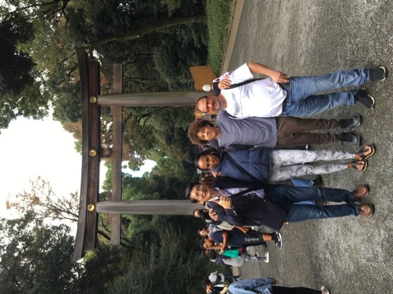 Tokyo Private Tour - My guests in front of Torii of Meiji Jingu Shrine. Torii is an entrance gate to the main hall of the shrine.