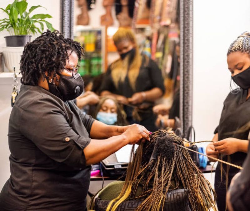 Lusaka Private Tour - A team of professional braiders at work in a hair studio