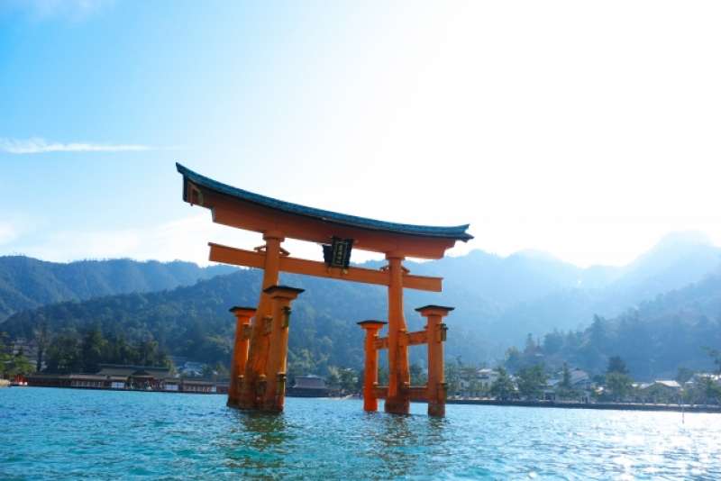 The centuries-old Itsukushima Shrine on Miyajima. The shrine and its torii gate are unique for being built over water, seemingly floating in the sea during high tide. It is outside Hiroshima city.