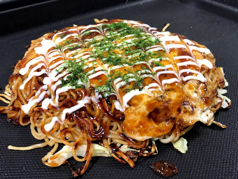 Hiroshima style Okonomiyaki, the Japanese savory pancake, a must-eat in Hiroshima